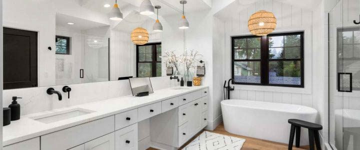 A bathroom remodeled with a luxurious design, artistic pendant lights, and clean-looking vanity area