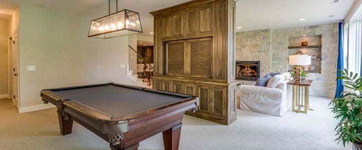 a luxury living room with a wooden divider in the middle and a billiard table