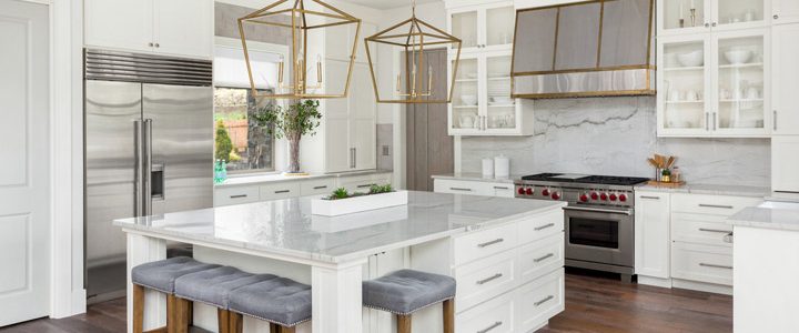 a kitchen remodeled into a contemporary design with an island and huge artistic lights